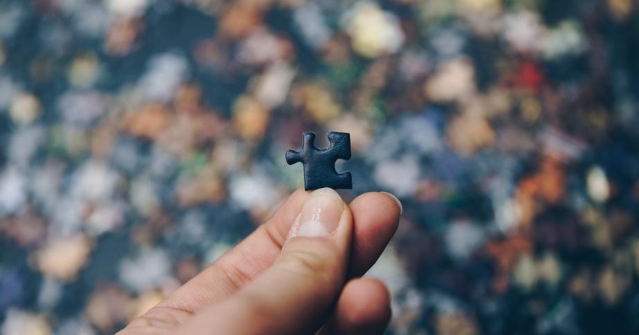 holding one piece of a puzzle while the rest is out of focus, a metaphor for marketing attribution